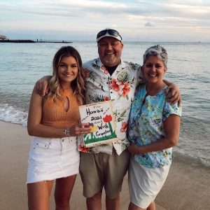 Husband, wife and daughter standing on Hawaii beach