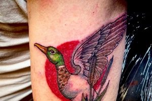 man's arm, tattoo, duck flying