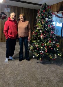 Man and woman standing by Christmas Tree