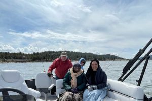 Four people on a boat on a lake