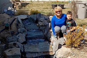 Woman and boy by waterfall