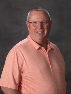 Man with glasses and peach shirt