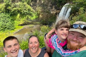 Family of four by waterfall