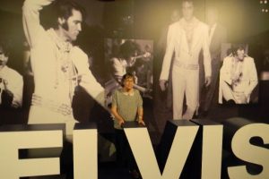 Women in front of Elvis photos
