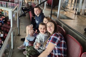 Family of four watching a hockey game