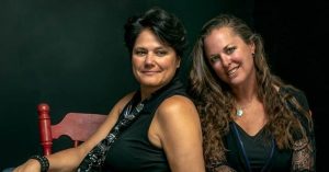 Two women sitting on a chair