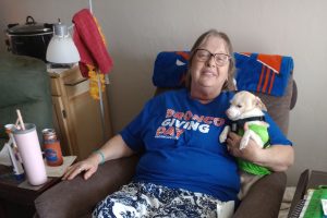 Woman holding dog sitting in a recliner