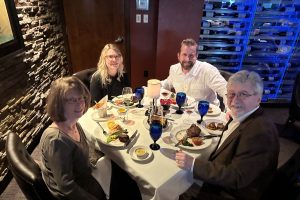 Two men and two women eating dinner at a restaurant