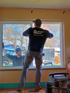 Two men installing windows