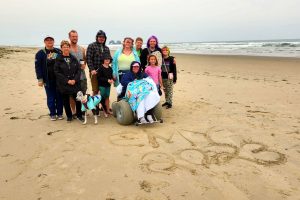 Family on the beach with a dog