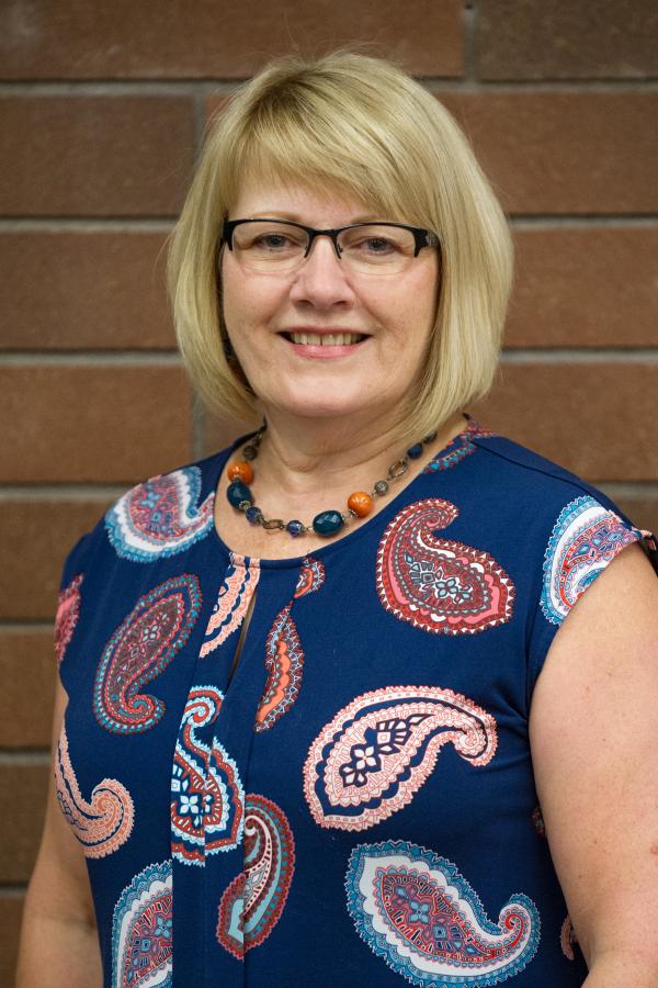 Woman with blonde hair and glasses