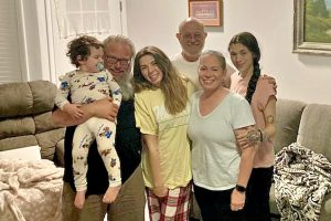 Family of six posing in a living room