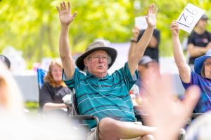 man with both hands up