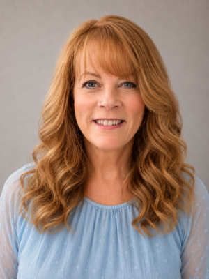woman with red hair and blue shirt