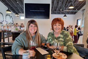 two women sitting at table