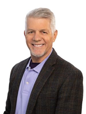 man with grey hair and black suit jacket