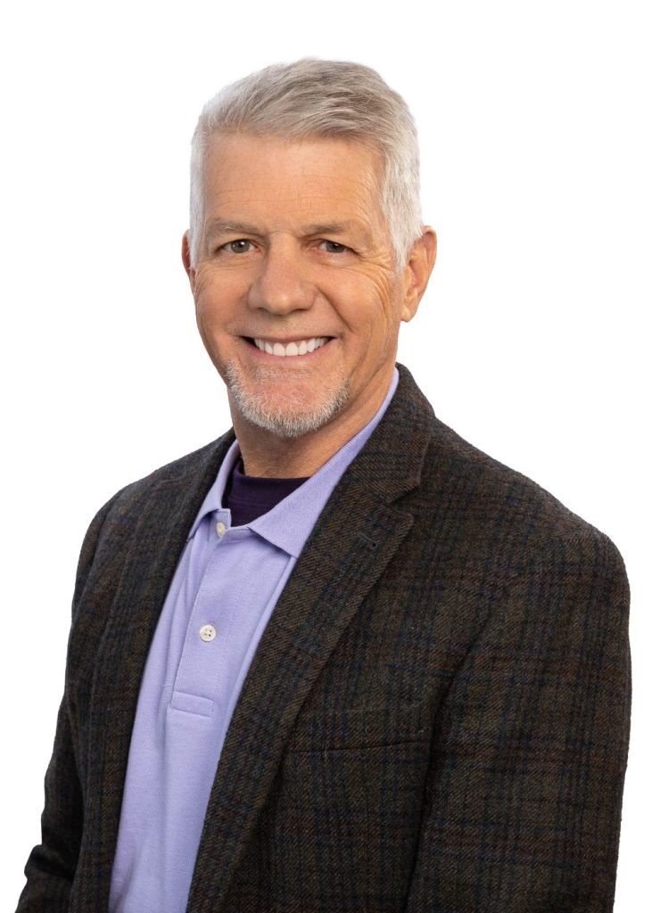 man with grey hair and black suit jacket
