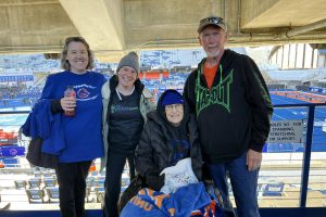 Three women and one man at a football game