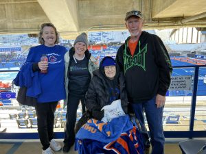 Three women and one man at a football game