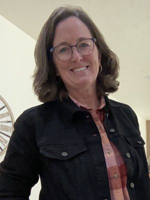 woman with brown hair and dark colored jacket