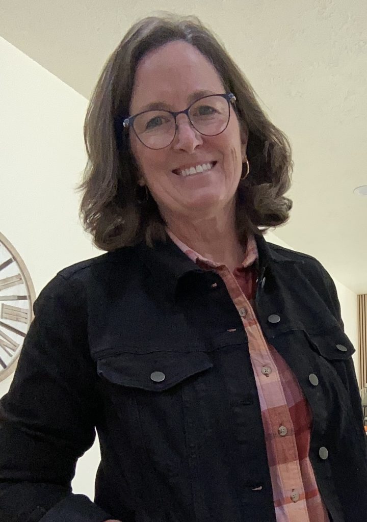 woman with brown hair and dark colored jacket