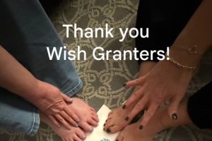 Hands and feet of four women with a Thank You Wish Granters note.