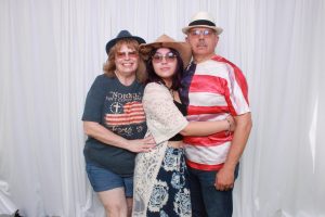Three people in a photo booth