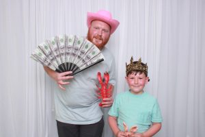 A man and his son in a photo booth