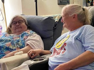 Two women smiling at each other