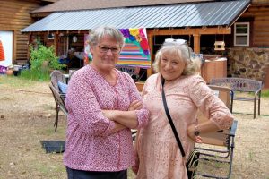 Two women in pink standing outside