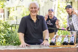 A man standing at a wine tasting stand