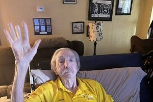 Man sitting in a recliner waving