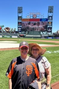 Two people standing on the San Francisco Giants field