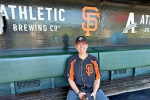 A man sitting on a bench in the San Francisco Giants baseball field