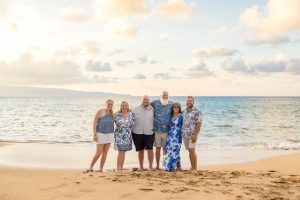 Six people standing on a beach in Maui