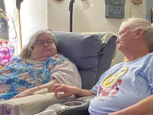 Two women smiling at each other