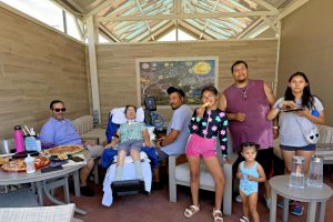 Four adults and four children at a waterpark cabana