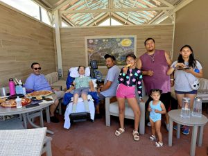 Four adults and four children at a waterpark cabana