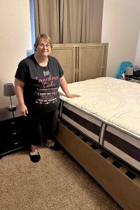Woman standing by a new mattress