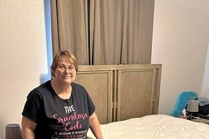 Woman standing by a new mattress